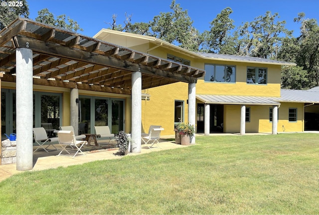 85789 Allbritain Ln, Eugene, OR 97405 - rear view of property featuring a standing seam roof, a pergola, stucco siding, and a yard