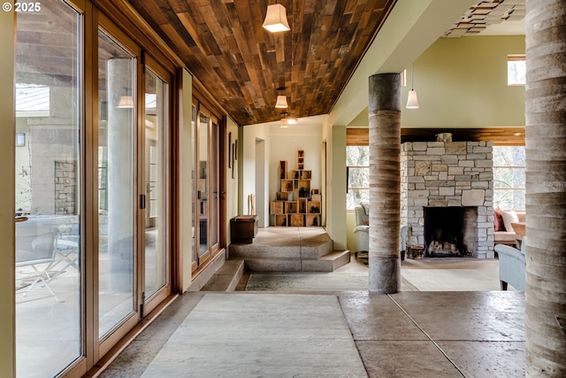 85789 Allbritain Ln, Eugene, OR 97405 - unfurnished living room featuring wood ceiling, a fireplace, and decorative columns