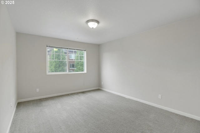 spare room with carpet floors and baseboards