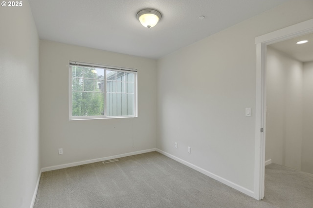unfurnished room with carpet and baseboards