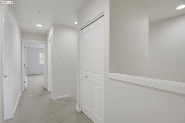 hall featuring light carpet, recessed lighting, and baseboards