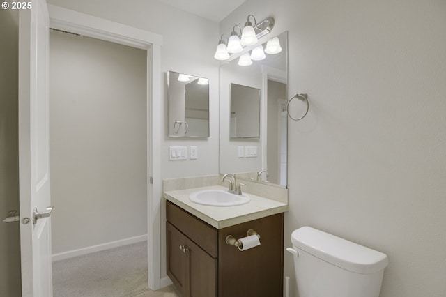 half bathroom with vanity and toilet
