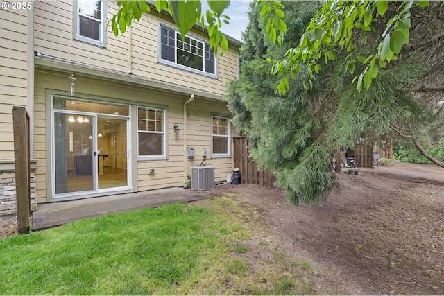 back of house featuring central AC unit