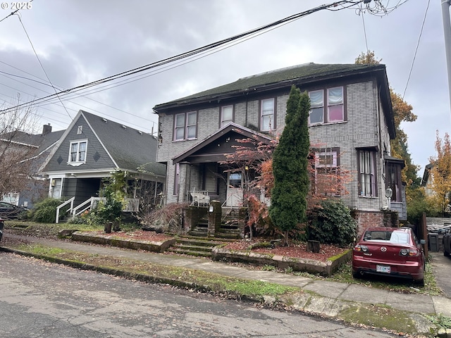 view of front of house with covered porch and brick siding