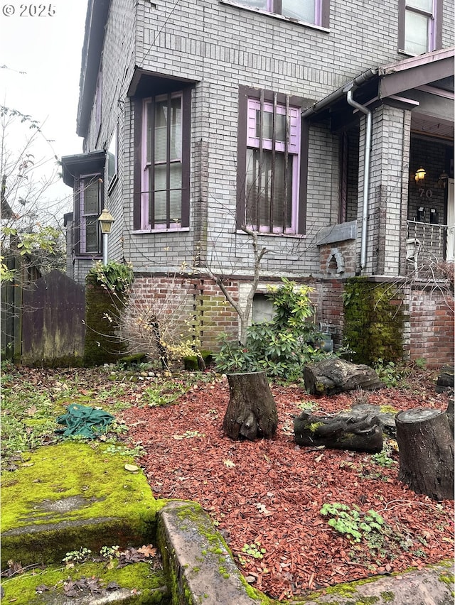 view of side of home featuring brick siding