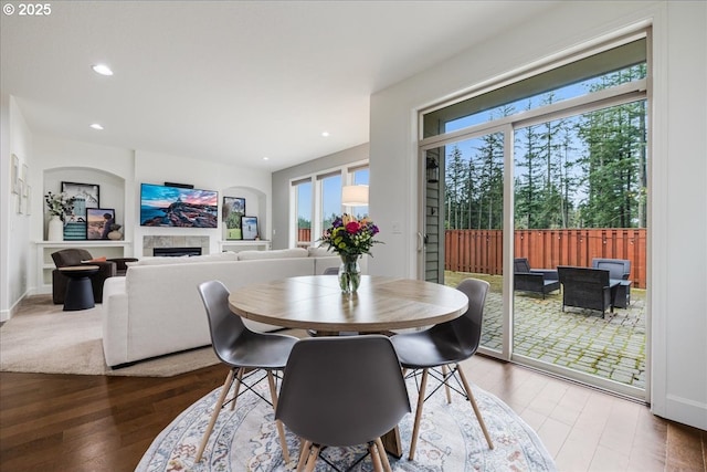 dining area featuring baseboards, a fireplace, wood finished floors, and recessed lighting