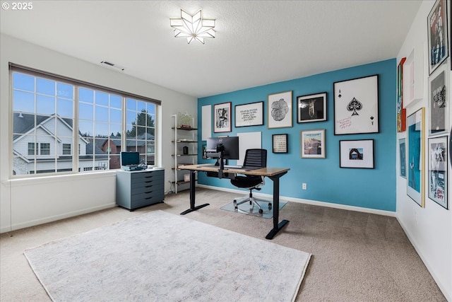 office area with carpet floors, visible vents, and baseboards