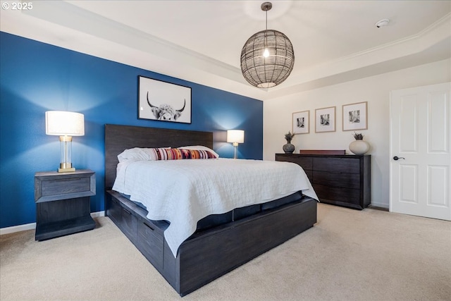 carpeted bedroom featuring baseboards and a tray ceiling