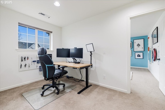 office space featuring visible vents, light carpet, and baseboards