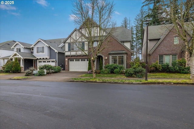 view of front of property featuring an attached garage, driveway, a shingled roof, and brick siding