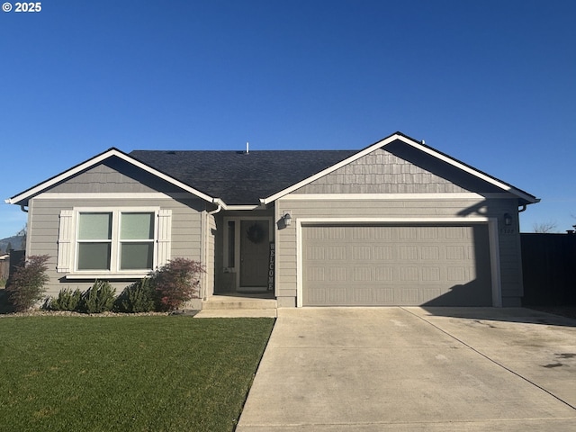 view of front of house featuring driveway, an attached garage, and a front lawn