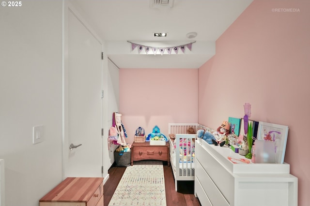 bedroom with dark wood-style flooring and visible vents