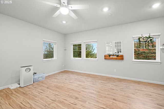 spare room featuring ceiling fan and light hardwood / wood-style flooring