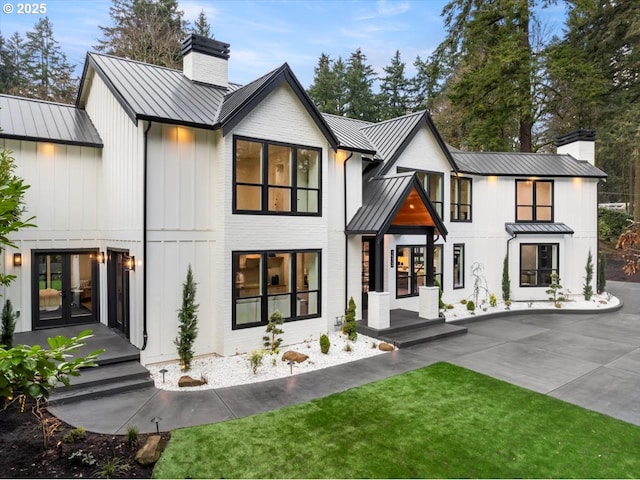 rear view of house featuring french doors and a yard