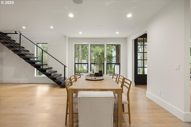 dining space with light hardwood / wood-style flooring