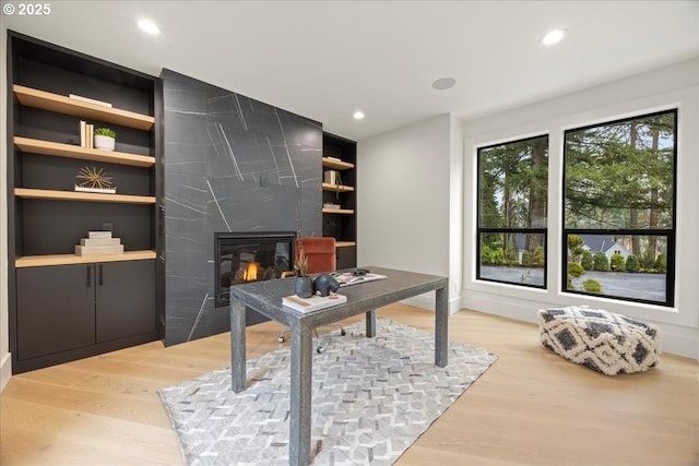 office area with wood-type flooring and built in features