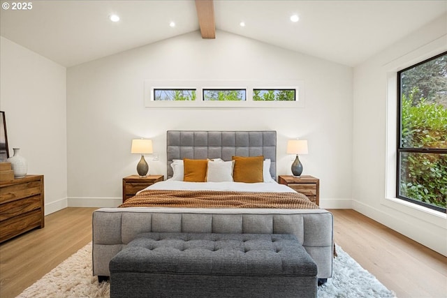 bedroom with lofted ceiling with beams and light wood-type flooring