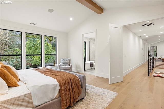 bedroom with ensuite bathroom, light hardwood / wood-style flooring, and lofted ceiling with beams