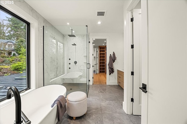 bathroom featuring separate shower and tub