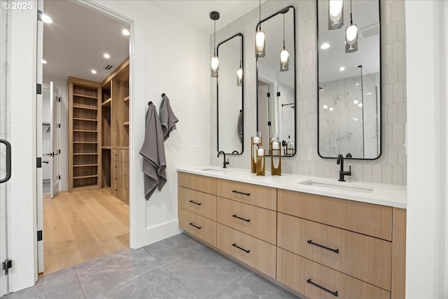 bathroom featuring walk in shower and vanity