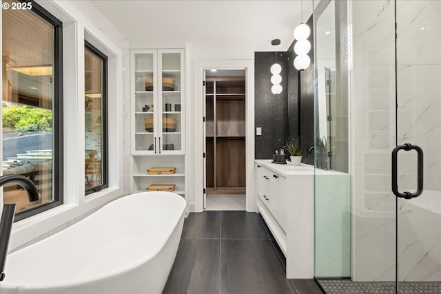 bathroom with vanity and shower with separate bathtub