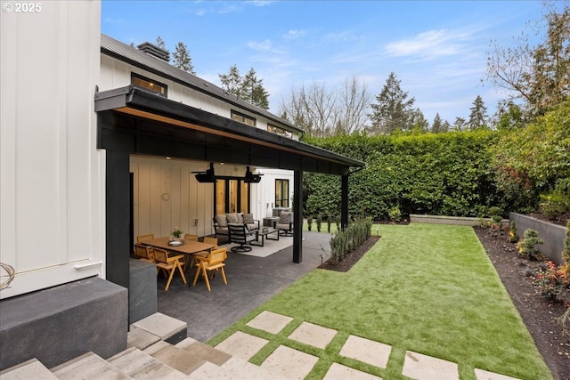 view of yard featuring an outdoor living space and a patio area