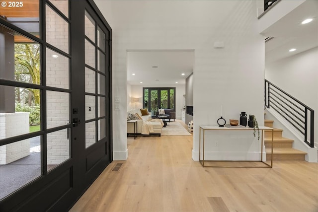 entrance foyer with french doors and light wood-type flooring