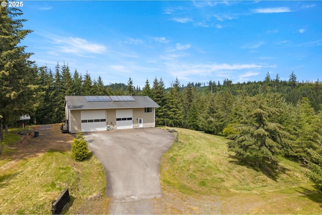 aerial view of property and surrounding area with a forest