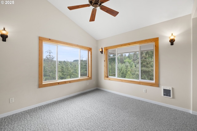 spare room with lofted ceiling, a ceiling fan, carpet flooring, baseboards, and heating unit
