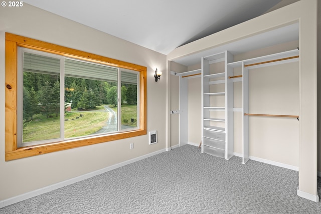 unfurnished bedroom featuring vaulted ceiling, carpet floors, and baseboards