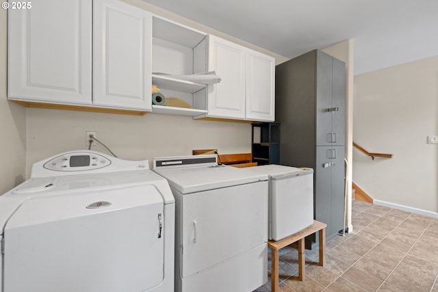 washroom with cabinet space and washer and dryer