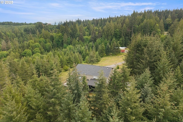 view of subject property with a forest