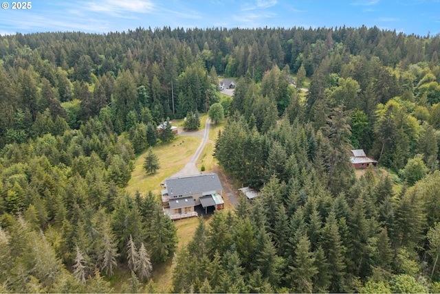 view from above of property with a heavily wooded area