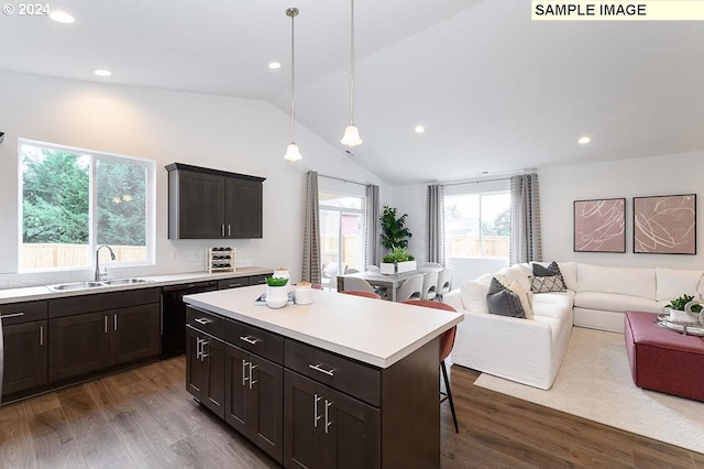 kitchen featuring a sink, open floor plan, vaulted ceiling, dark wood-style flooring, and light countertops