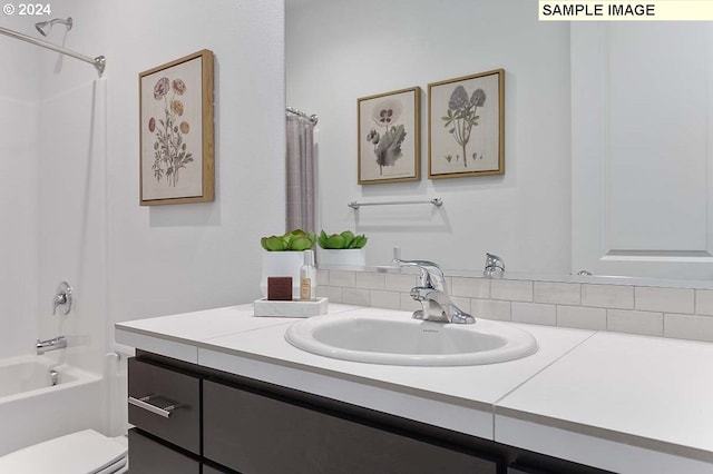 bathroom with vanity, shower / bath combo, and toilet