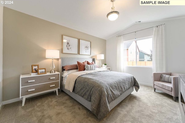 bedroom with carpet, vaulted ceiling, and baseboards