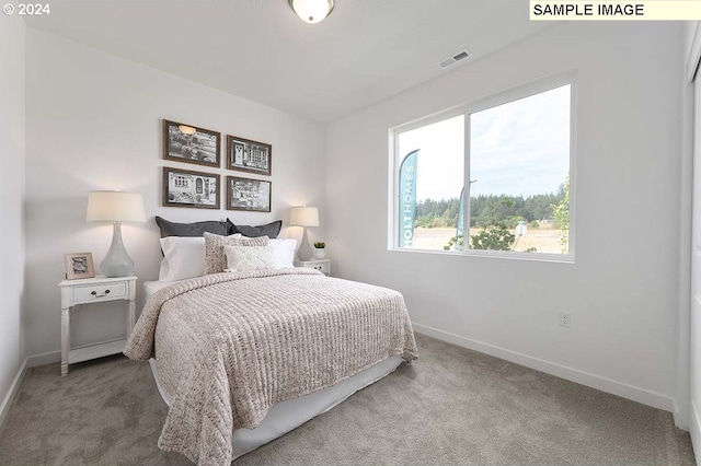 carpeted bedroom featuring baseboards