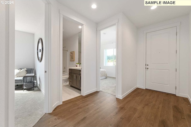 entryway with wood finished floors, recessed lighting, and baseboards