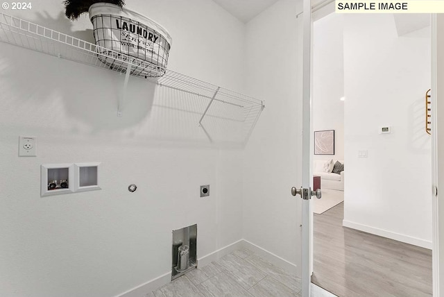 laundry room with washer hookup, hookup for an electric dryer, gas dryer hookup, and baseboards