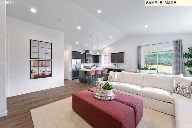 living area with vaulted ceiling, dark wood-style flooring, and recessed lighting