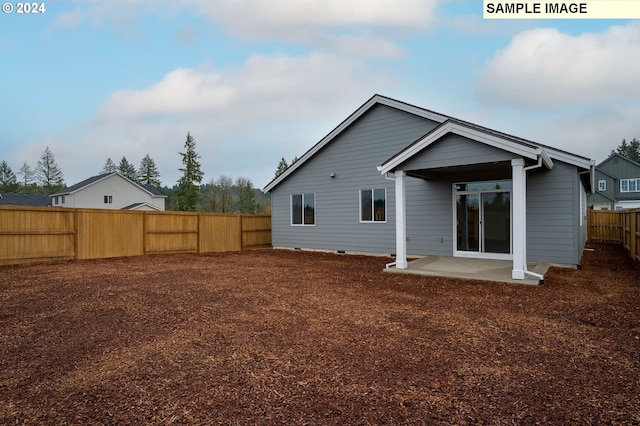 back of house featuring a fenced backyard, a patio area, and crawl space