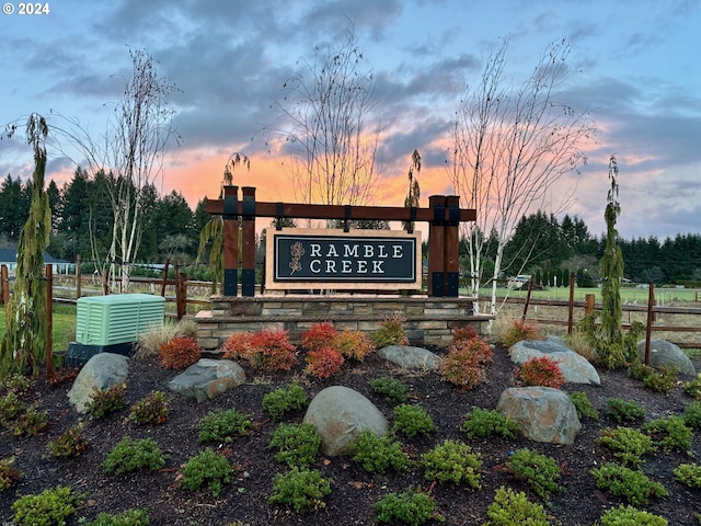 community / neighborhood sign featuring fence