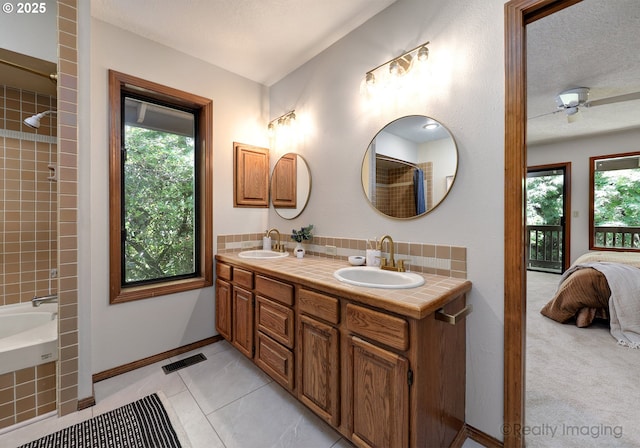 1929 SW Broadleaf Dr, Portland, OR 97219 - full bath with double vanity, plenty of natural light, ensuite bathroom, bathtub / shower combination, and a textured ceiling