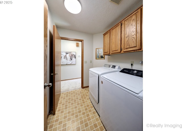 1929 SW Broadleaf Dr, Portland, OR 97219 - laundry area featuring separate washer and dryer, cabinet space, a textured ceiling, and light floors