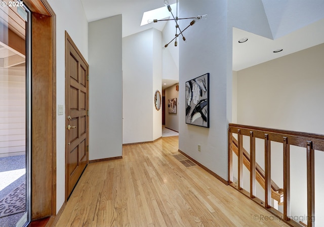 1929 SW Broadleaf Dr, Portland, OR 97219 - corridor with light wood finished floors, high vaulted ceiling, a skylight, and recessed lighting