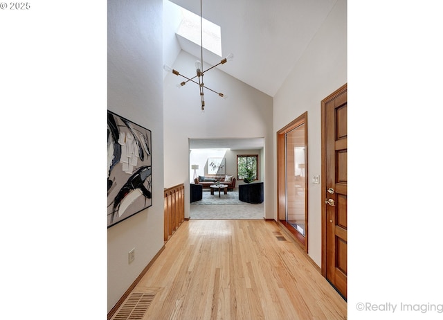 1929 SW Broadleaf Dr, Portland, OR 97219 - entrance foyer with a chandelier, high vaulted ceiling, and light wood-style floors