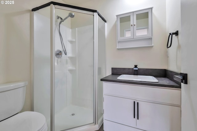 bathroom featuring vanity, toilet, and walk in shower