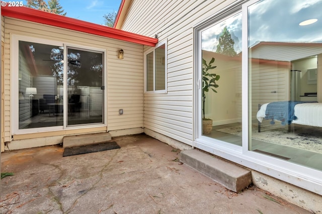 view of exterior entry featuring a patio area