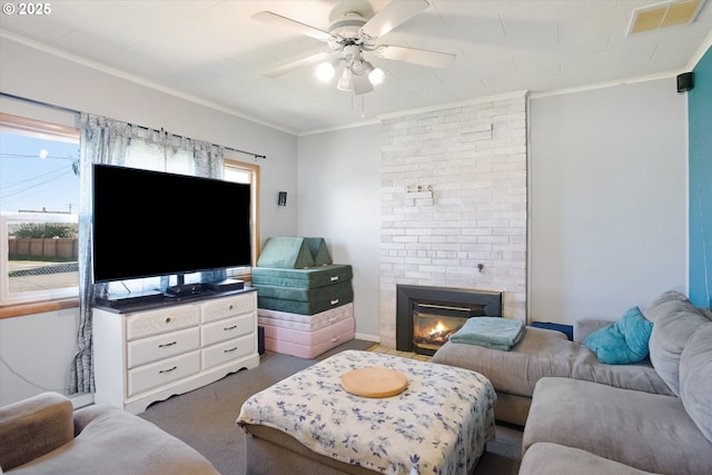 208 E 3rd St, Molalla, OR 97038 - living area featuring ornamental molding, a ceiling fan, a fireplace, and carpet