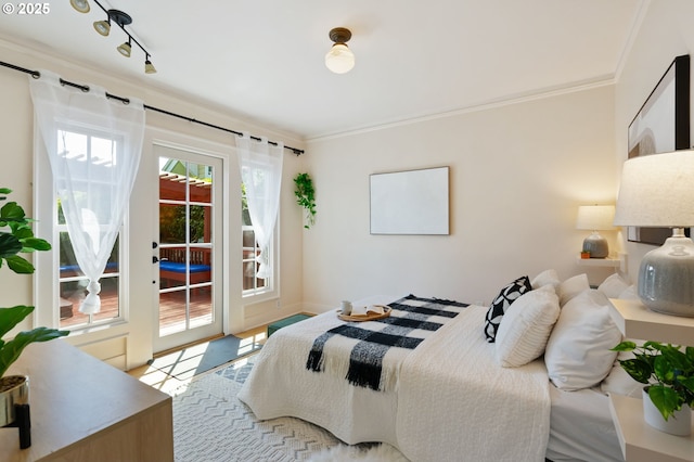 bedroom featuring access to exterior and crown molding